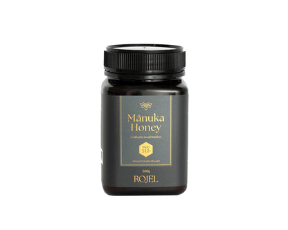 Manuka Honey jar with black lid and label on a white background