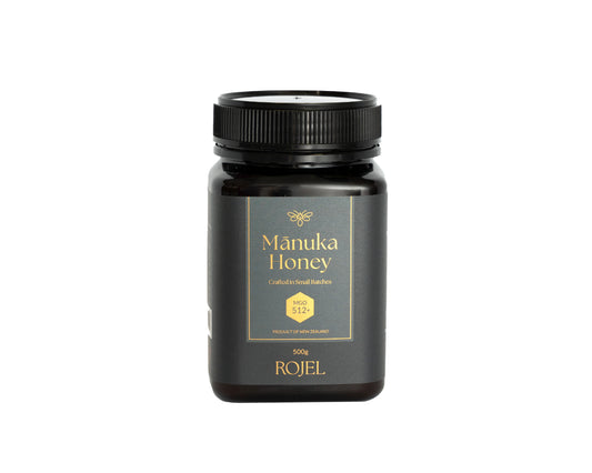Manuka Honey jar with black lid and label on a white background