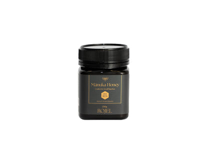 Jar of Manuka Honey with a black lid on a white background
