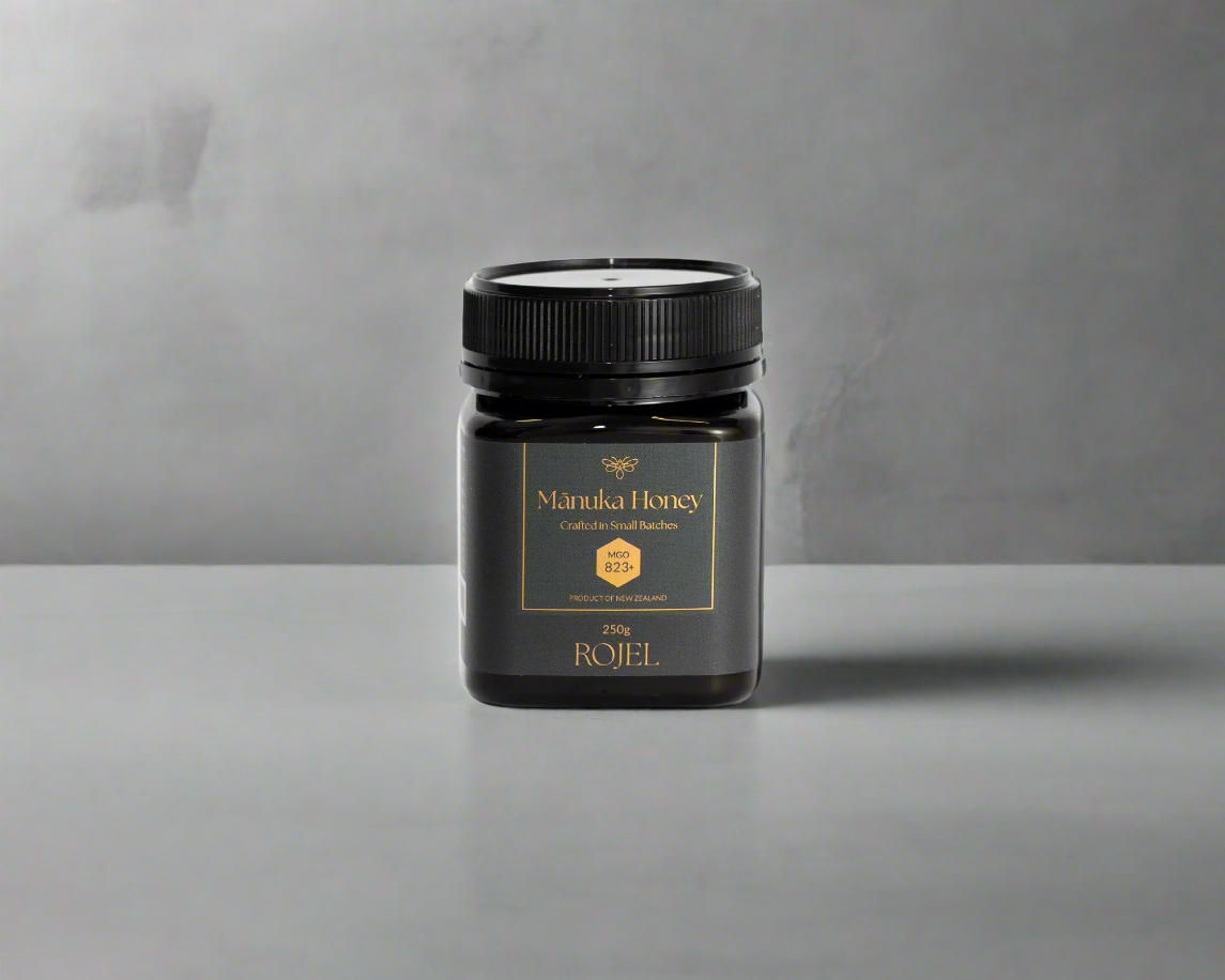 Jar of Manuka Honey on a gray background